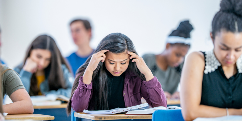 student thinking at desk