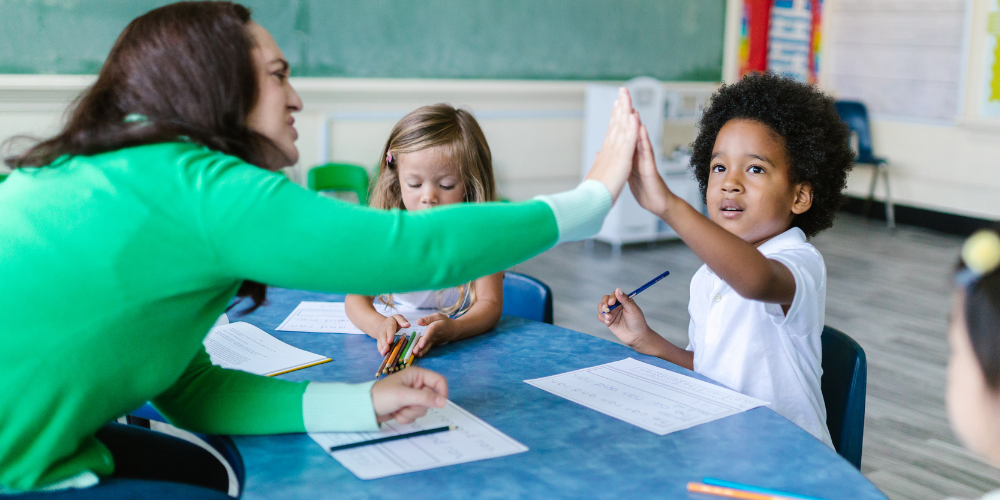 5.13.25 c teacher support for elementary student with a high-five